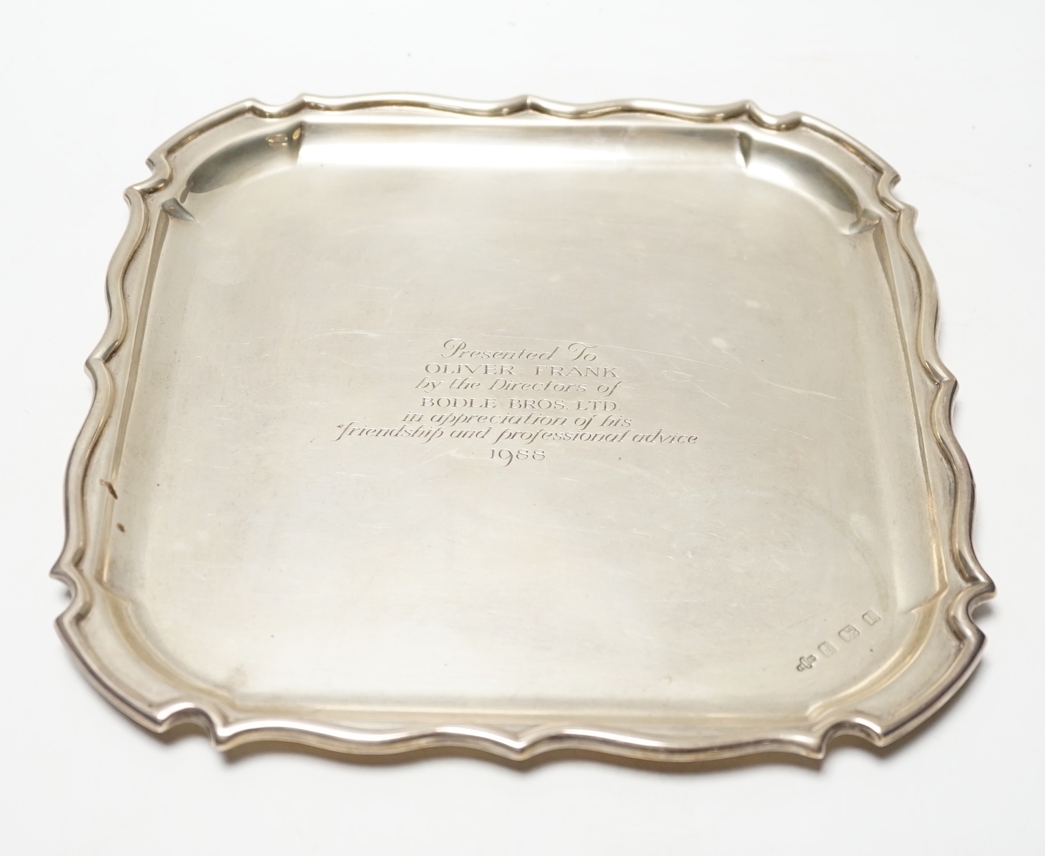 A George V silver shaped square presentation salver, with later engraved inscription, A.E. Poston & Co Ltd, Birmingham, 1935, 25.6cm, 23oz.